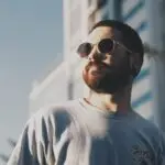 man in white crew neck shirt wearing black sunglasses